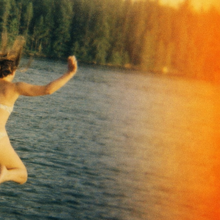 A 100% crop of the right edge of a Holga photograph: a warm orange light leak, softened detail and a dark vignetted corner